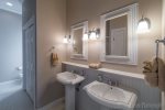 spacious bathrooms with charming pedestal sinks